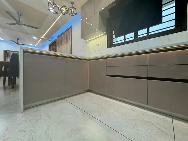 Grey L-shape handleless modular kitchen with tall units