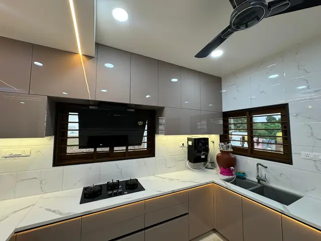 Grey U-shape modular kitchen with built-in hob and window