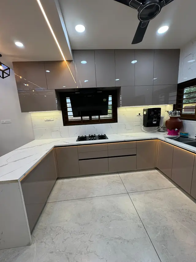 Beige and grey U-shape modular kitchen with granite countertop