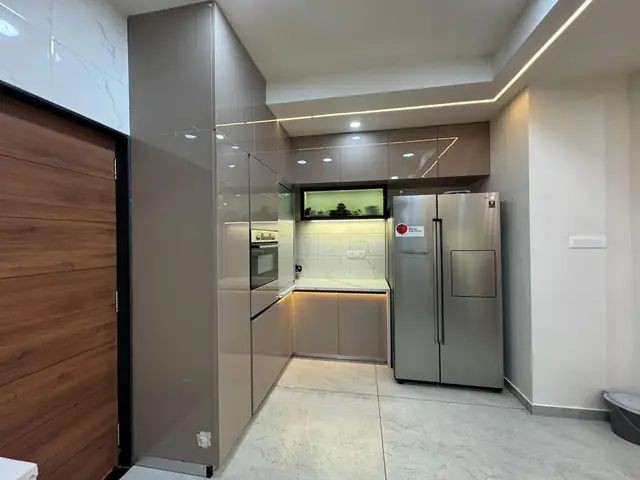 Floor-to-ceiling tall storage units with wooden finish and fridge housing