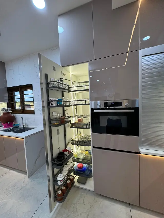 Tall pantry pull-out unit beside built-in oven column