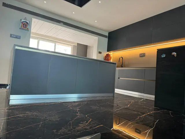 Dark marble island counter with backlit profile lighting