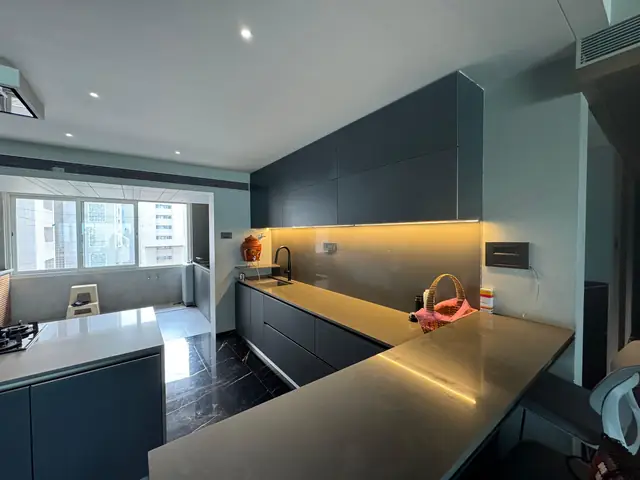 Dark themed island kitchen with integrated lighting