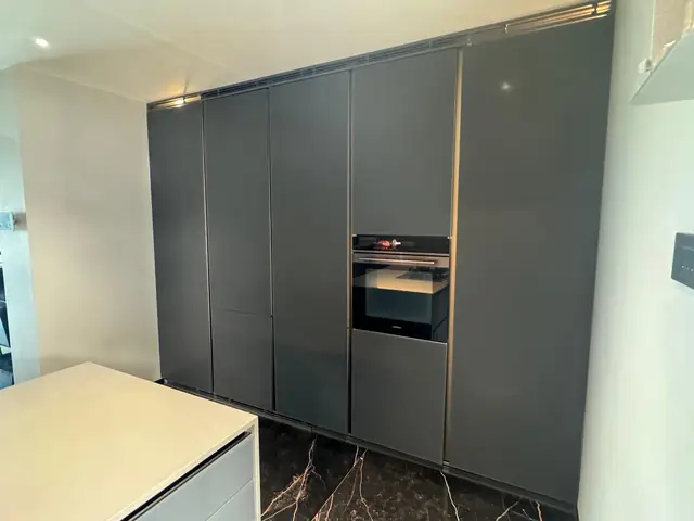 Tall unit wall with built-in oven and concealed storage