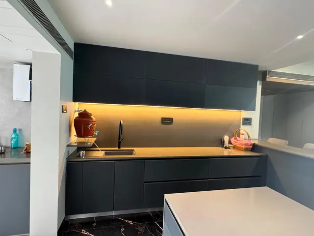 Navy blue modular kitchen with under-cabinet lighting