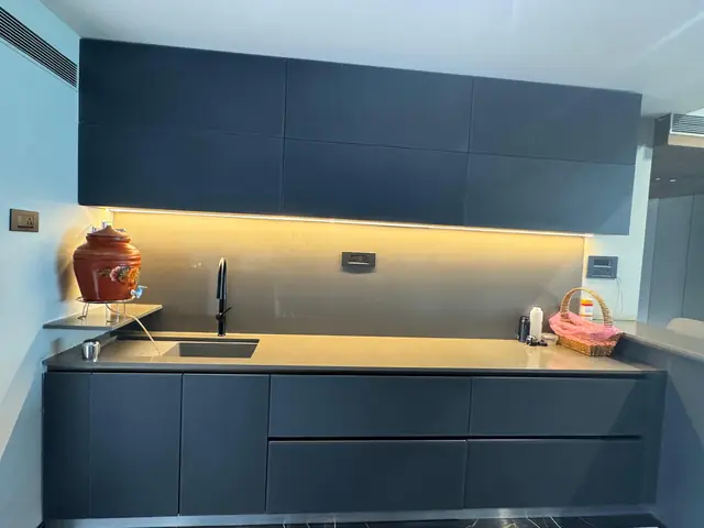 Navy handleless kitchen with sink and long worktop