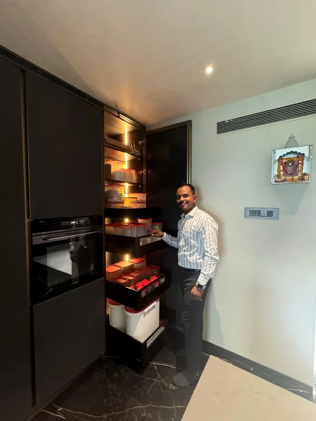 Tall dark units with pull-out baskets and built-in oven