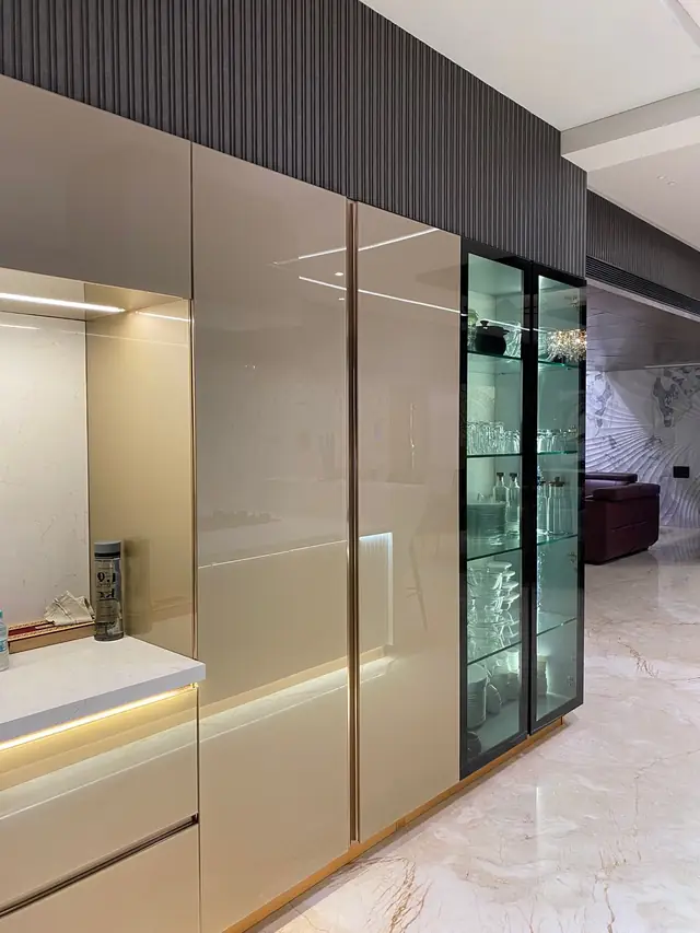 High gloss beige tall units with sliding glass partition