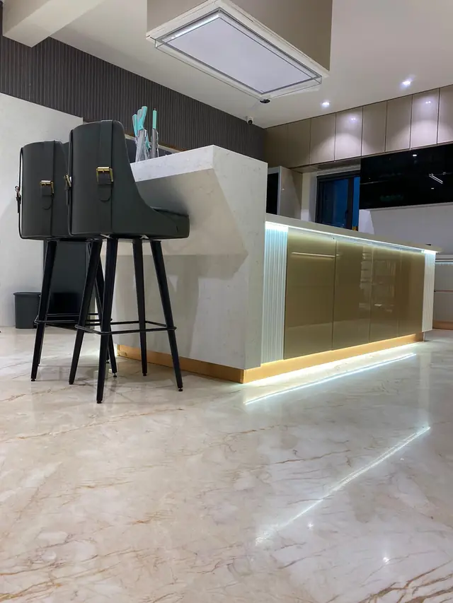 Island kitchen with bar seating and backlit skirting