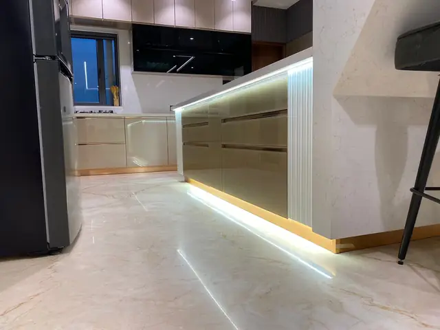 Open plan island kitchen with LED profile lighting