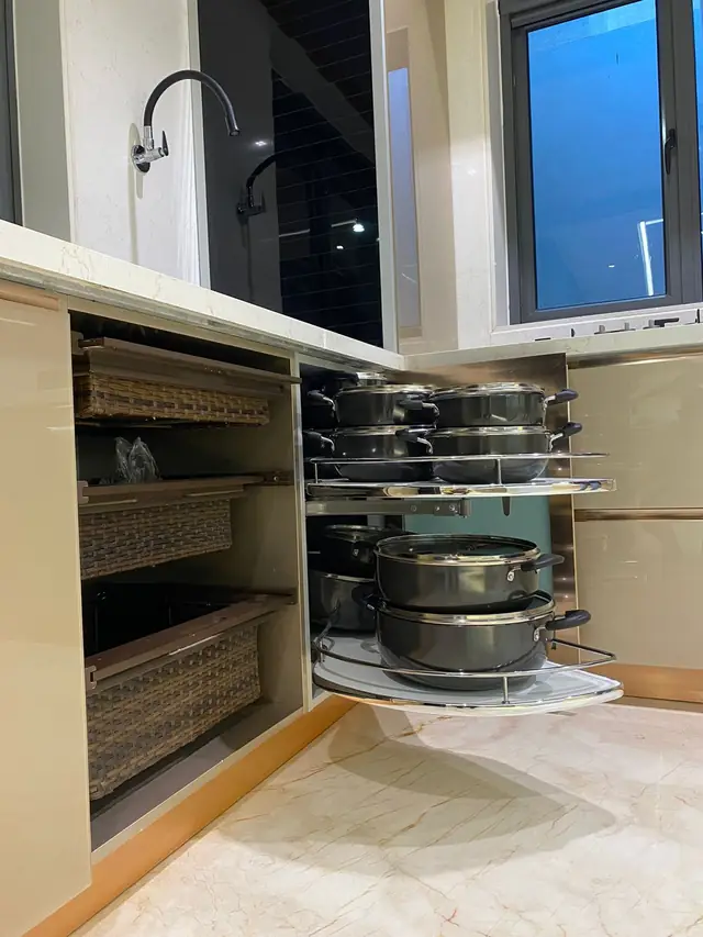 Corner pull-out unit holding large cooking vessels