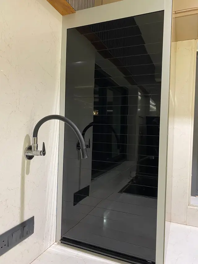 Dark gloss tall storage unit with handleless shutters