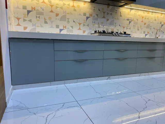 Grey base units with patterned marble backsplash