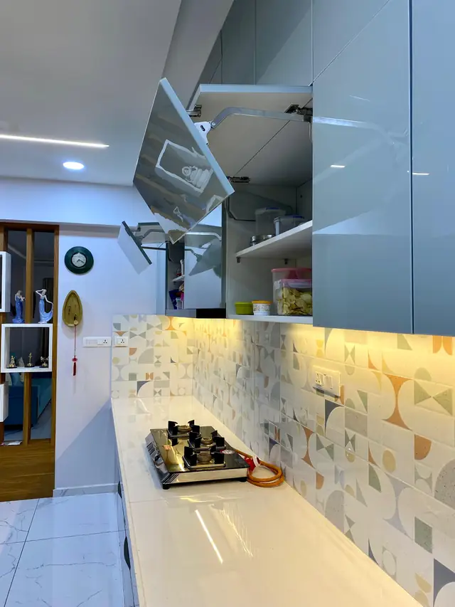 Lift-up wall unit opened above the kitchen worktop