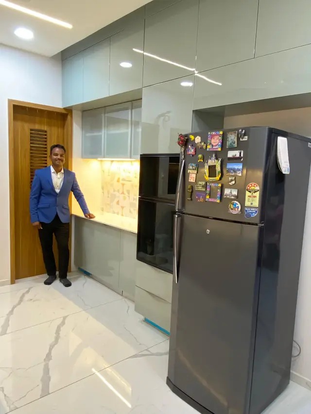 Tall storage unit with refrigerator housing in a modular kitchen
